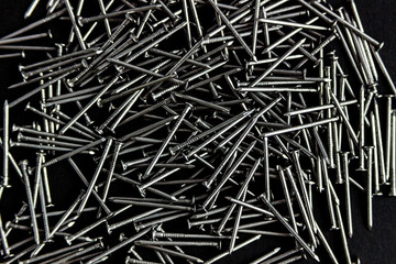 metal nails scattered on a black background