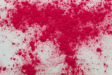 scattered pink dye powder on white background