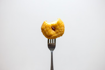 bite donut with fork in white isolated background