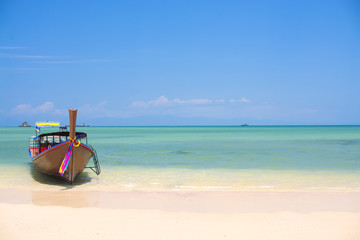 Wooden boat on a white sand beach, tropical beach in Thailand