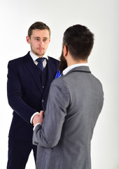 Handshake concept. Businessmen shaking hands, successful deal or acquaintance. Businessmen, business partners meeting, white background. Business partners on serious faces handshaking