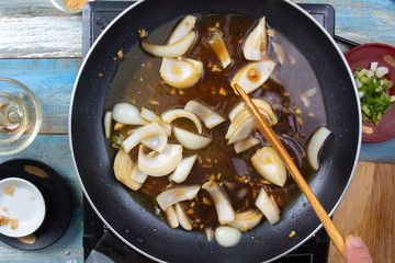 Chef stir fry onion in pan