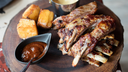Gourmet Pork ribs and corn bread on a natural wooden board
