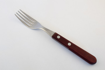 Fork with wooden handle on white background