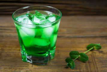 ice and mint cocktail on a wooden background. mojito with ice 
