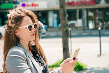 YOUNG BEAUTIFUL WOMAN READING MESSAGE WITH SMART PHONE