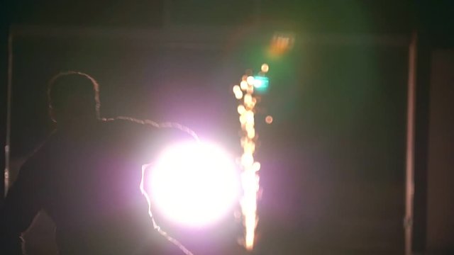Martial arts in in front of sparklers - cheat Kick somersault in the air, slow-motion
