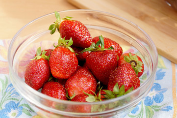 Fresh strawberry in a transparent salad bowl