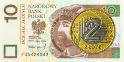 2 polish zloty coin against 10 polish zloty bank note