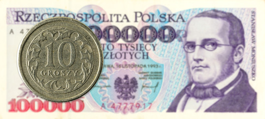 10 polish groszy coin against 100000 polish zloty bank note