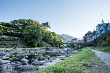 Fototapeta na wymiar Small waterfalls on River in Yumoto, Hakone, Japan
