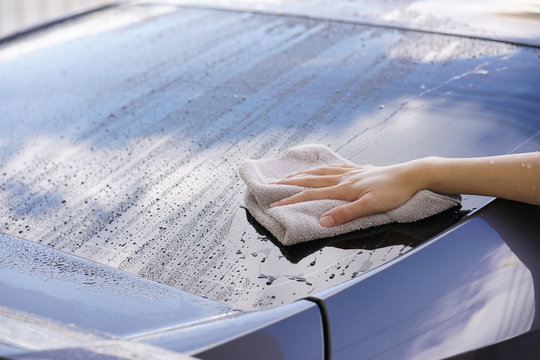 Women Hand Dry Wiping Car Surface With Microfiber Cloth After Washing.