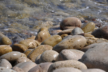 Waves crashing on the rocks on the pebble beach