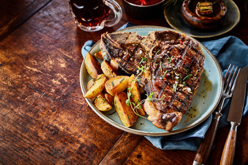 Grilled spicy T-bone steak with potato wedges
