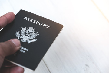 Hands of a young man who is filing a passport for inspection