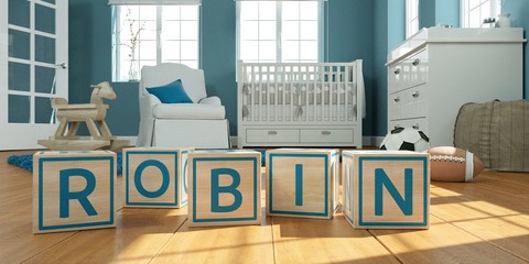 The name robbin written with wooden toy cubes in children's room