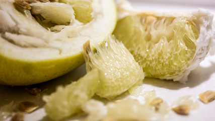 Chunks of fresh pomelo on a white background