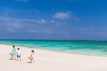 Fototapeta na wymiar Mother and kids at tropical beach