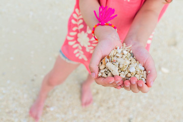 Girl holding sea shells