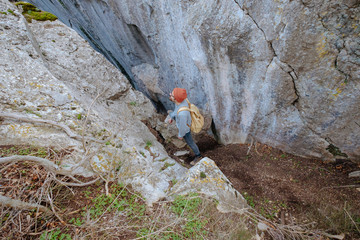 Man with backpack hiking in mountains