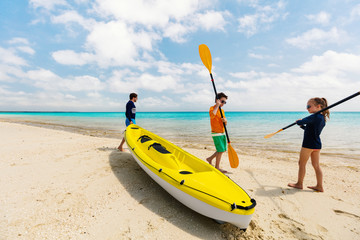 Family kayaking at tropical ocean