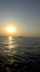 Fototapeta premium sunset on the ocean with boat