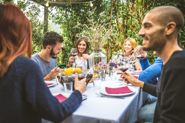 Friends having dinner in garden
