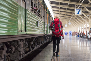 backpacker lady travels by train during her holiday