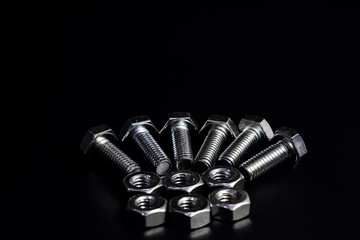 Screws placed on a black background.1