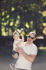 happy father with son playing in park