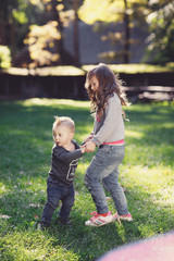 Happiness boy and girl fun outdoor under sunlight