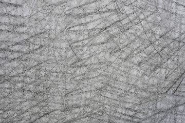 gray crayon doodles on paper background texture