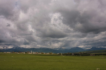 Fototapeta premium mountains village under stormy sky