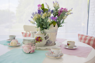 Table setting. Tea drinking. Interior in light colors. Feast