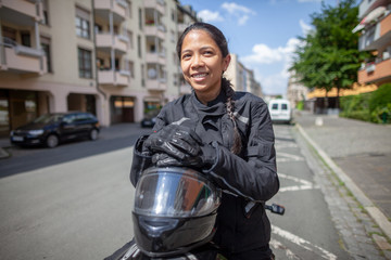 Woman with a black helmet on a motorbike