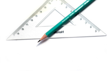 Green pencil, ruler,  on white background