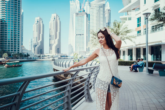 Happy beautiful unrecognizable tourist woman in fashionable summer white dress