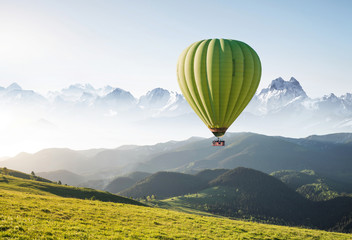 Naklejka premium Air ballon above mountains at the summer time. Concept and idea of adventure