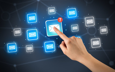 Female hand touching unread mail icon with more envelope icons around it 