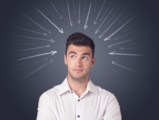 Young casual businessman with arrows pointing to his head