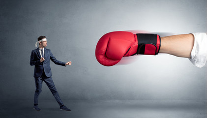 Little man fighting with a giant red boxing glove
