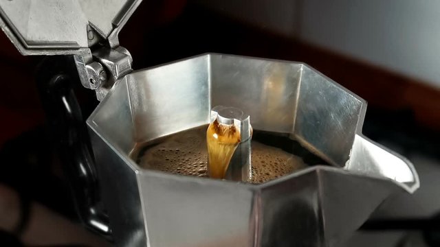 Brewing espresso coffee in a stovetop moka express.