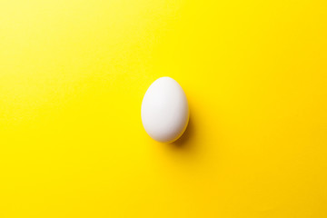 white egg on a yellow background