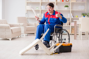 Fototapeta na wymiar Disabled man repairing chair in workshop