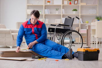 Disabled man laying floor laminate in office