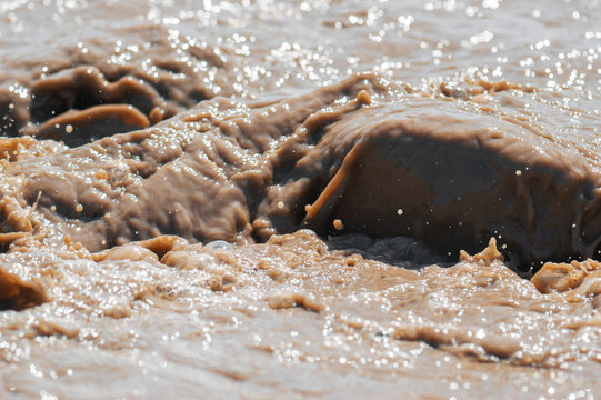 Streams and splashes of dirty water close-up background image