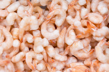 Frozen peeled shrimps. background