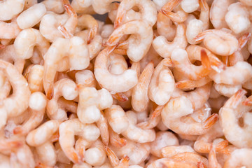 Frozen peeled shrimps. background