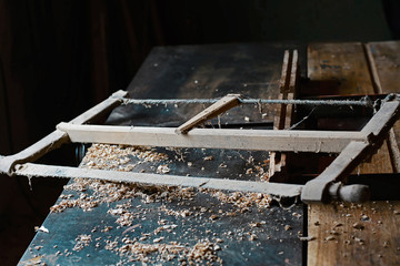 Wood planer and shavings at carpenters workshop, old woodworking tool, sawdust, antique saws. selective focus