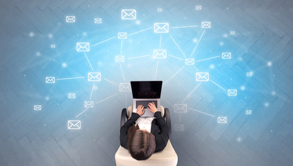 Mail symbols with woman using device in a beige chair